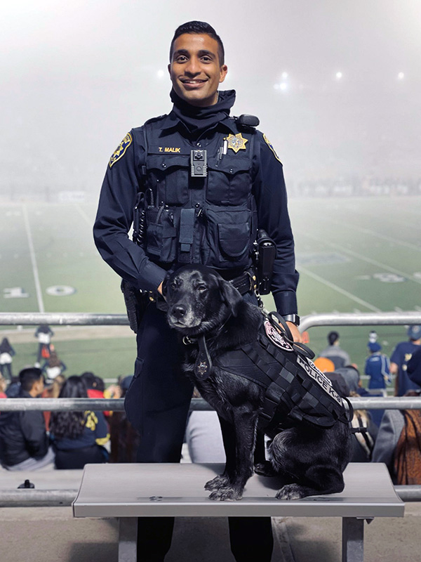 Photo of police officer and dog at stadium