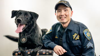 Officer Kwong posing with K9 Charlie.