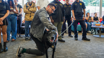 K9 Charlie being pet by students on campus.