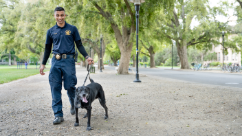 CORE Officer Malik and K9 Charlie walking through the Quad.