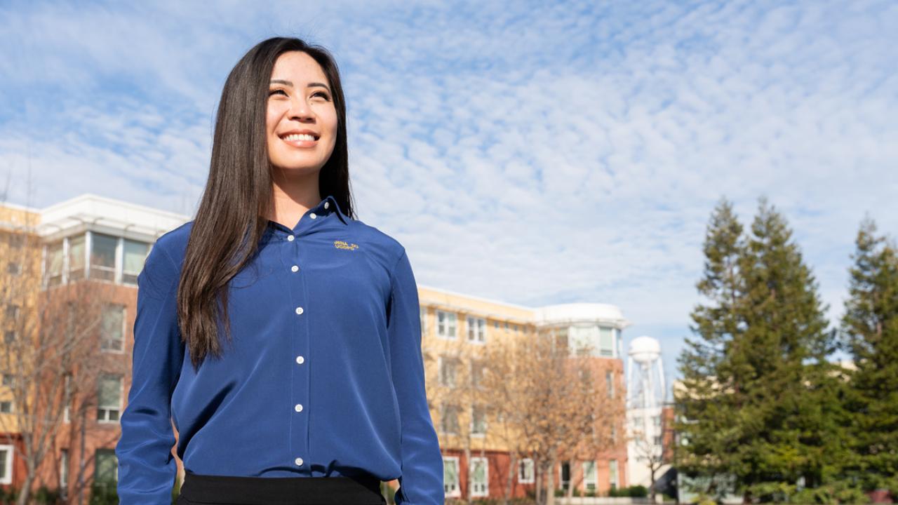 CORE Officer Jena Du smiles and looks out onto campus with the UC Davis water tower in the background
