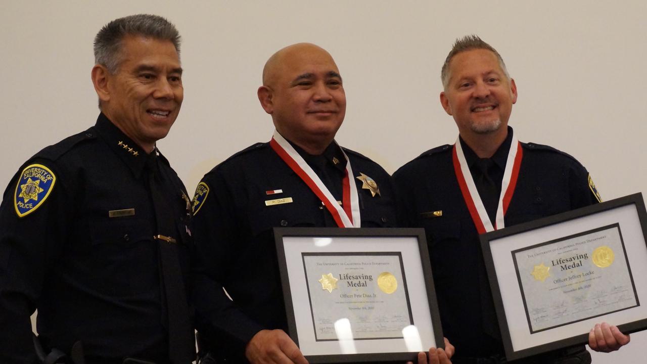 Police chief with two officers receiving lifesaving awards