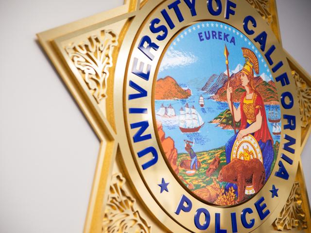 Close-up detail of a wall plaque of the University of California Police star.