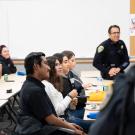 students in classroom with police officers as teachers