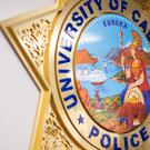 Close-up detail of a wall plaque of the University of California Police star.