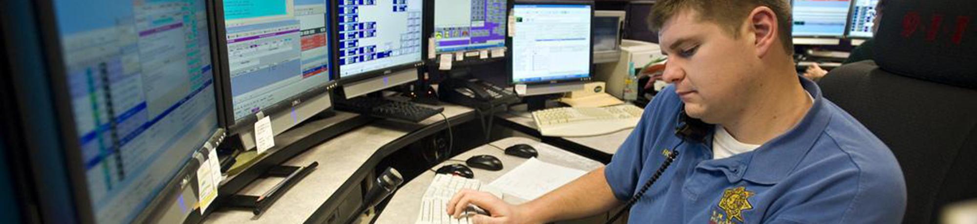 UC Davis Police employee typing on a computer