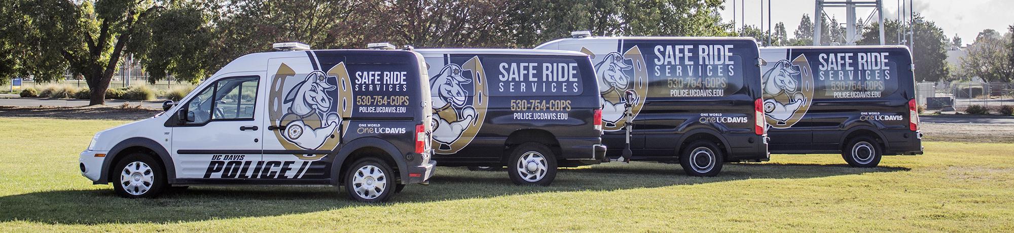 Line up of Safe Ride vans parked on campus
