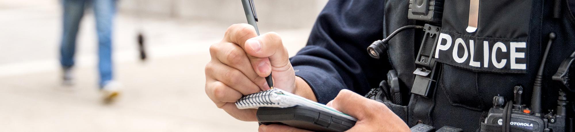 Officer writing in a notepad