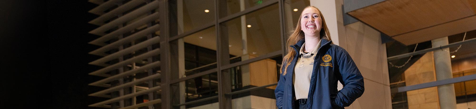 Aggie Host smiling outside of the Mondavi Center in the evening.